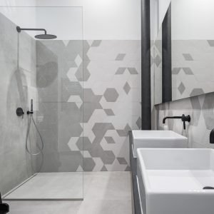New design bathroom with shower and two basins, in gray and white with black details