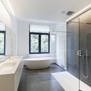Bathtub in corian, Faucet and shower in tiled bathroom.
